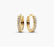 gold-plated hoop earrings curve elegantly around the ear.